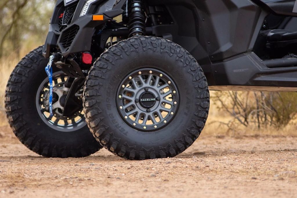 A detail of tires on a rocky ground.