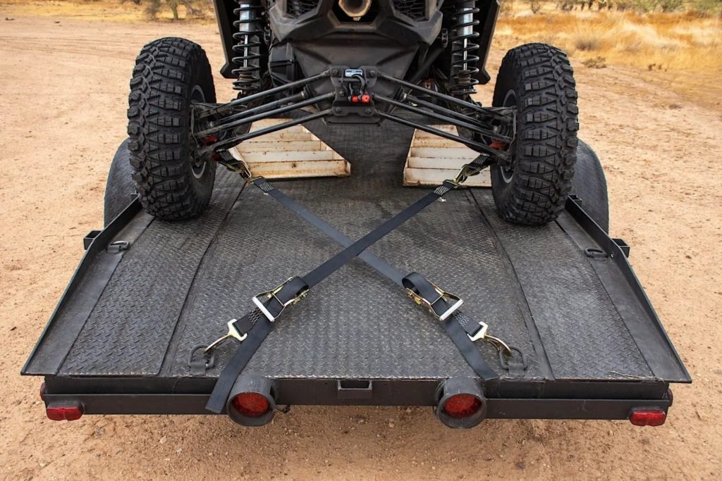 A UTV strapped to a trailer.